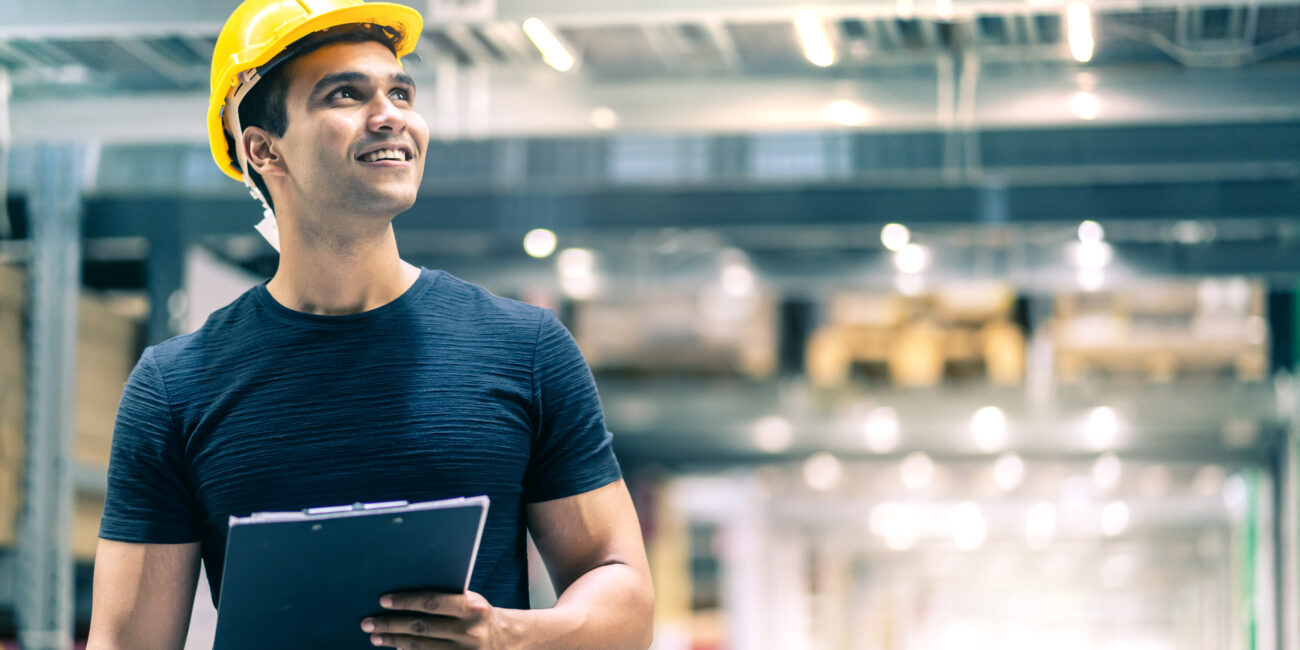 smart indian engineer man wearing safety helmet doing stock tick